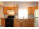 Kitchen with light wood cabinets, black appliances, and a window over the sink at 1627 Orlando Sw St, Atlanta, GA 30311