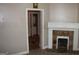 Living room with stone fireplace and view into laundry room at 1627 Orlando Sw St, Atlanta, GA 30311