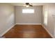 Empty living room features hardwood floors, a ceiling fan, and a window with natural light at 1627 Orlando Sw St, Atlanta, GA 30311