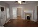 Living room with hardwood floors, fireplace, and doorway with glass french doors at 1627 Orlando Sw St, Atlanta, GA 30311