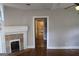 Living room with hardwood floors, fireplace, and view through the doorway of the bathroom at 1627 Orlando Sw St, Atlanta, GA 30311