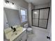 Clean bathroom with tile floors, a shower with black trim, and a vanity with a modern faucet at 7910 Tintern Trce, Duluth, GA 30097