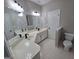 Bright bathroom featuring double sink vanity with modern fixtures and a separate toilet area at 7910 Tintern Trce, Duluth, GA 30097