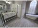 Bathroom featuring a double sink vanity, a soaking tub, and a decorative window at 7910 Tintern Trce, Duluth, GA 30097