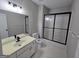 Standard bathroom with a single sink vanity, toilet, and shower with sliding doors at 7910 Tintern Trce, Duluth, GA 30097