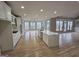 Spacious kitchen featuring a large island with quartz countertop and modern white cabinetry and hardwood floors at 7910 Tintern Trce, Duluth, GA 30097