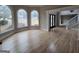 Bright living room featuring large windows, hardwood floors, elegant trim and staircase with white railing at 7910 Tintern Trce, Duluth, GA 30097