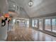 Bright living room with soaring ceilings, hardwood floors, a view of the kitchen and access to a deck at 7910 Tintern Trce, Duluth, GA 30097
