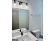 Light and bright bathroom with a large mirror, vanity, and updated fixtures and lighting at 415 Dove Ln, Social Circle, GA 30025