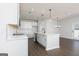 Bright kitchen featuring white cabinets, stainless appliances, and a center island with pendant lighting at 509 Altahama, Locust Grove, GA 30248