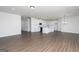 Open-concept living area with hardwood floors and white kitchen cabinets at 509 Altahama, Locust Grove, GA 30248
