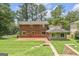Expansive backyard with brick patio and a lush lawn, perfect for outdoor entertaining and relaxation at 708 Delanie Way, Stone Mountain, GA 30083