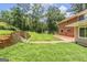 Spacious backyard with a brick patio and lush greenery at 708 Delanie Way, Stone Mountain, GA 30083