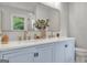 Stylish bathroom with double vanity, gold fixtures, a large mirror, and light blue cabinets at 708 Delanie Way, Stone Mountain, GA 30083