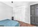 Neutral bedroom with hardwood floors, ceiling fan, closet, and an painted door, offering a comfortable space at 708 Delanie Way, Stone Mountain, GA 30083