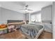 A well-lit bedroom with hardwood floors, built-in storage, and two twin-size beds with gray comforters at 708 Delanie Way, Stone Mountain, GA 30083