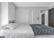 A bright bedroom with gray walls, closet space, and a comfortable bed with gray and white linens at 708 Delanie Way, Stone Mountain, GA 30083