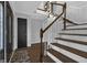 Elegant entryway featuring a wooden staircase with a modern light fixture and detailed trim work at 708 Delanie Way, Stone Mountain, GA 30083