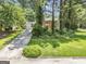 Beautifully landscaped home with lush greenery, a spacious lawn, and a long driveway at 708 Delanie Way, Stone Mountain, GA 30083