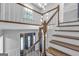 A grand foyer featuring hardwood stairs, a modern chandelier, and a view of the front door at 708 Delanie Way, Stone Mountain, GA 30083