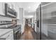 Spacious kitchen featuring stainless steel appliances and a view to the dining and living rooms at 708 Delanie Way, Stone Mountain, GA 30083