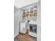 Functional laundry room featuring washer, dryer, and built-in shelving for organized storage at 708 Delanie Way, Stone Mountain, GA 30083