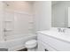 Modern bathroom featuring white fixtures, including a tub-shower combo, toilet, and single vanity at 714 Ocmulgee Crossing, Locust Grove, GA 30248