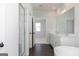 Bright bathroom featuring a double vanity, soaking tub, and glass shower at 714 Ocmulgee Crossing, Locust Grove, GA 30248