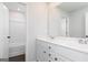 Bright bathroom featuring a double vanity with white cabinets and a shower-tub combo with white tiling at 714 Ocmulgee Crossing, Locust Grove, GA 30248