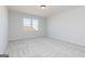 Bright and spacious bedroom with neutral carpet and two windows providing ample natural light at 714 Ocmulgee Crossing, Locust Grove, GA 30248