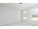Well-lit bedroom with neutral carpet, two windows, and light gray walls providing a calming atmosphere at 714 Ocmulgee Crossing, Locust Grove, GA 30248