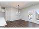 Dining area featuring wood floors, a modern light fixture, and access to the backyard at 714 Ocmulgee Crossing, Locust Grove, GA 30248