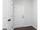 Hallway featuring two doors with dark wood-look floors and light gray walls at 714 Ocmulgee Crossing, Locust Grove, GA 30248