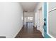 Hallway featuring wood-look floors, light gray walls and open door to living space at 714 Ocmulgee Crossing, Locust Grove, GA 30248