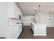 Bright kitchen featuring white cabinets, an island with seating, and pendant lighting at 714 Ocmulgee Crossing, Locust Grove, GA 30248