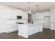 Bright kitchen with white cabinets, a center island, and stainless steel appliances at 714 Ocmulgee Crossing, Locust Grove, GA 30248