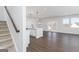 Open floorplan with a kitchen island and living area, showcasing modern design and natural light at 714 Ocmulgee Crossing, Locust Grove, GA 30248