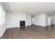 Bright living room with a fireplace, hardwood floors, and neutral walls at 714 Ocmulgee Crossing, Locust Grove, GA 30248