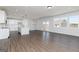 Open-concept living room with wood-look floors and lots of natural light at 714 Ocmulgee Crossing, Locust Grove, GA 30248