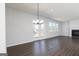 Open living space with a cozy fireplace, wood floors, and French doors leading to the patio at 714 Ocmulgee Crossing, Locust Grove, GA 30248