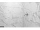 Close-up of a tiled shower with marble-look accent tile at 714 Ocmulgee Crossing, Locust Grove, GA 30248