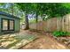 View of the backyard with gravel landscaping, mature trees, and a rock border at 216 Leyden St, Decatur, GA 30030