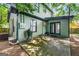 Backyard featuring a concrete patio, gravel landscaping, and the home's rear entrance at 216 Leyden St, Decatur, GA 30030