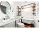 Stylish bathroom featuring a modern vanity, round mirror, and a vintage-style clawfoot bathtub at 216 Leyden St, Decatur, GA 30030