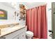 Charming bathroom featuring a granite vanity, wooden shelving, and a privacy curtain at 216 Leyden St, Decatur, GA 30030