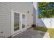 Back patio features white siding, a concrete patio, and white-trimmed French doors for outdoor living at 2375 Lexington Ln, Cumming, GA 30040