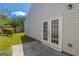 Cozy back patio features white siding, grass, a concrete patio, and white-trimmed French doors for outdoor living at 2375 Lexington Ln, Cumming, GA 30040