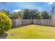 Fenced backyard with green grass and mature trees at 2375 Lexington Ln, Cumming, GA 30040