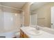 Bathroom with a shower-tub, vanity, toilet, and mirror at 2375 Lexington Ln, Cumming, GA 30040