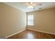 Cozy bedroom with hardwood floors, neutral paint, and a ceiling fan at 2375 Lexington Ln, Cumming, GA 30040